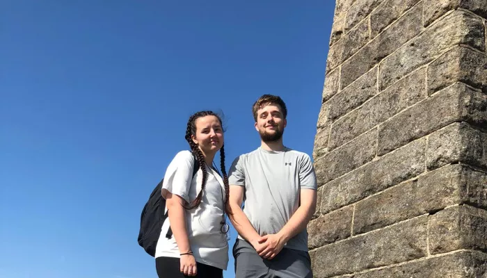 Young couple outside looking into the camera