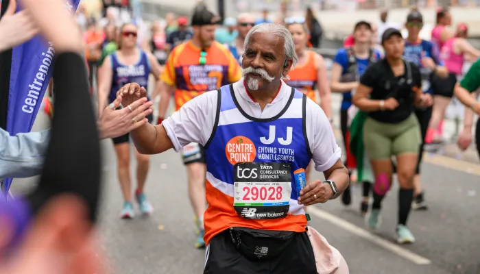 Man running high fiving people cheering
