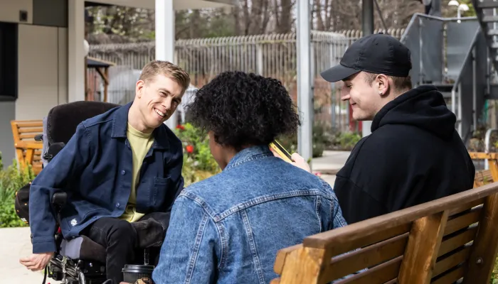 3 young people talking and smiling