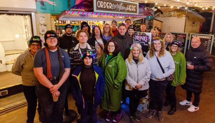 A group of sleep out participants smile facing the camera
