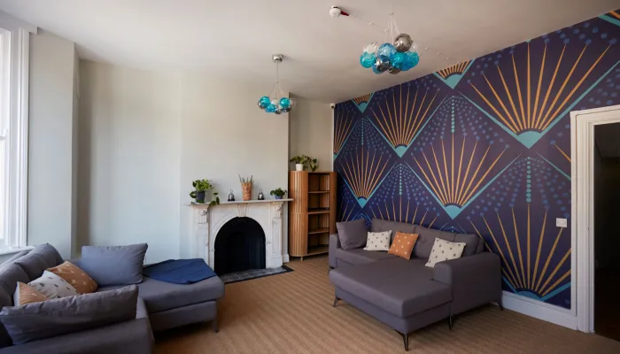 Centrepoint accommodation recently refurbished with new sofas, lighting and stylish wallpaper through Nationwide More Than a Roof