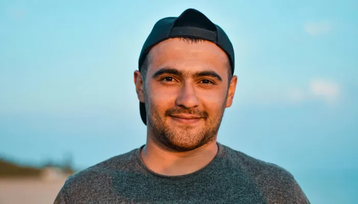 Young man looking into camera and smiling