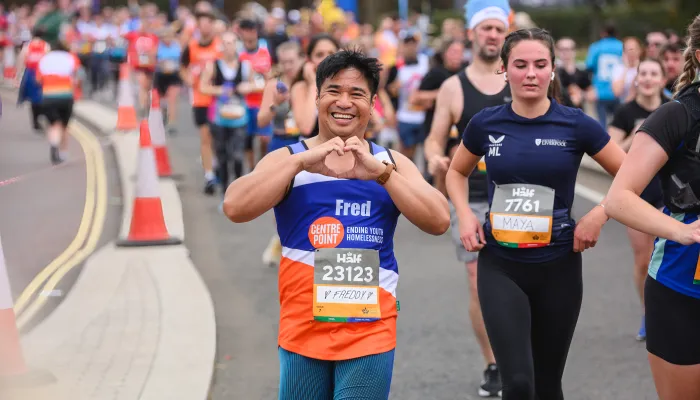 man running making heart shape with hands