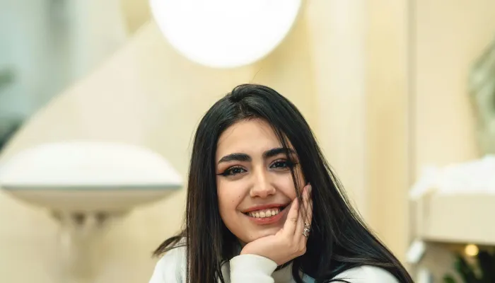 Young woman smiling having a coffee