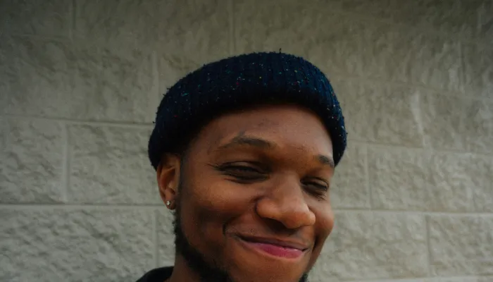 Young man smiling in a beanie hat