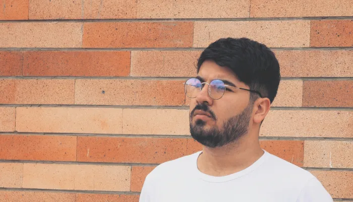 Young man in glasses looking away