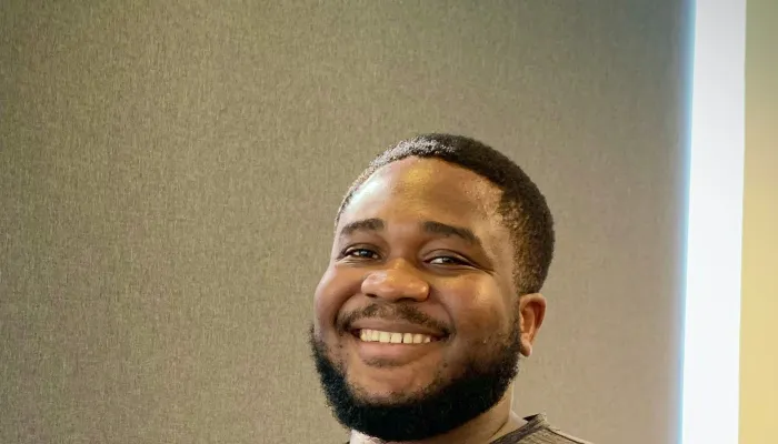 Man smiling with cross arms