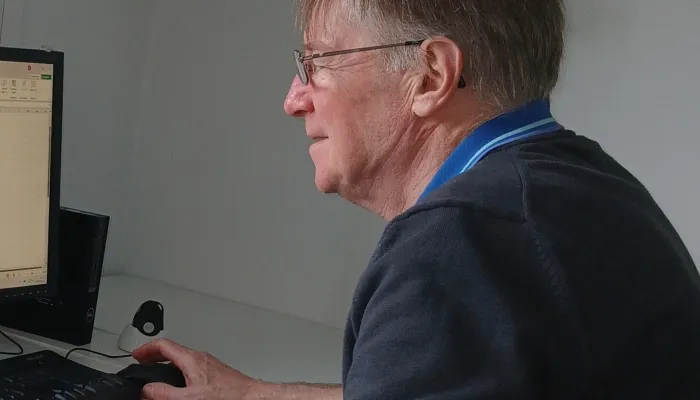 Profile of man sat at computer