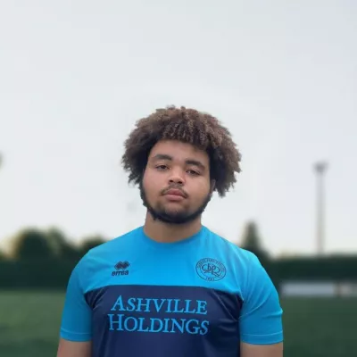 Young person outside wearing a football top