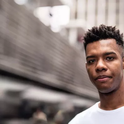 Young person standing outside in white T-shirt