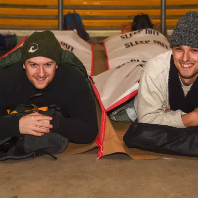 Two people on Sleep Out lying on the floor