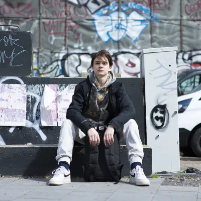 Young person sitting outside