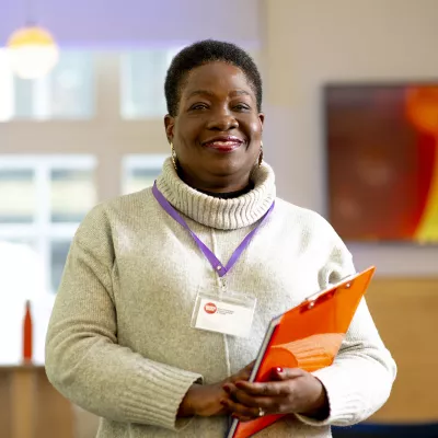 Person with lanyard and clipboard