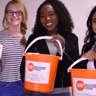 Young people holding Centrepoint collection buckets