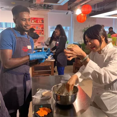 Ching He Huang makes dumplings with a Centrepoint young person