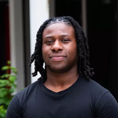 Young person in black t-shirt smiling