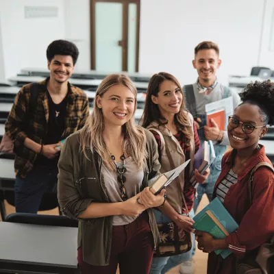 A group of young people stand in a learning environment.