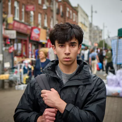 Carim stood in a bus street clutching his bad