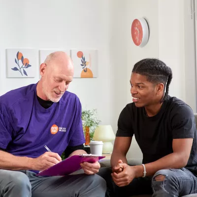 A counsellor sits and talks with a young person in a Centrepoint service 