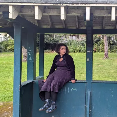 Young person sitting at bus stop