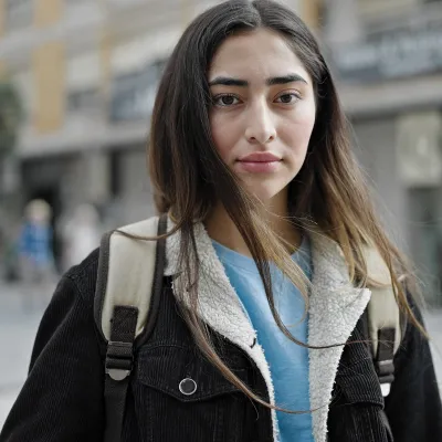 A young woman looks nervous on the street.