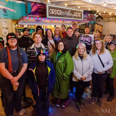 A group of sleep out participants smile facing the camera