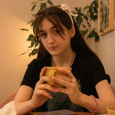 Young woman looking at camera holding a mug