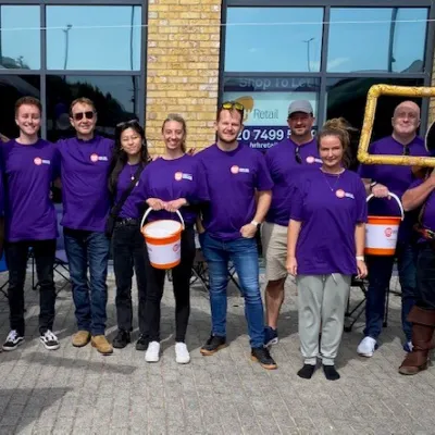 10 members of the Bellrock Group in purple Centrepoint T Shirts with collection buckets
