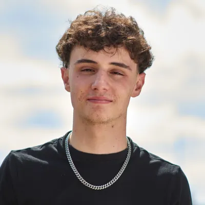 Young person standing outside looking to camera