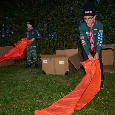 two cub scouts rolling out their sleeping mats