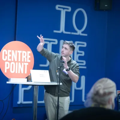 A speaker talks passionately at the National Youth Homelessness Conference 2025