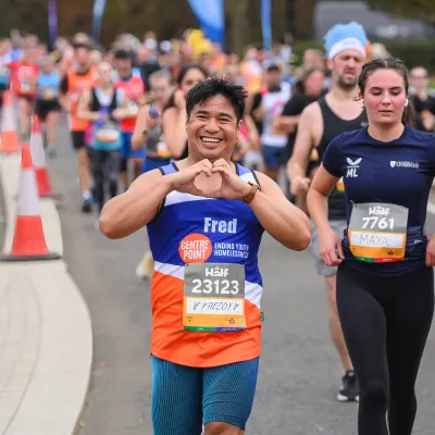 man running making heart shape with hands