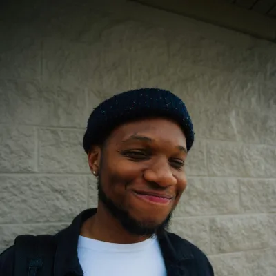 Young man smiling in a beanie hat