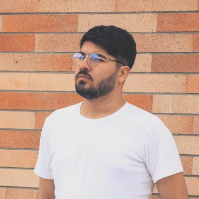 Young man in glasses looking away
