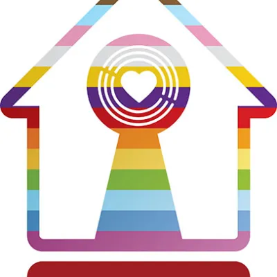 A house-shaped symbol with rainbow colours forming a keyhole in the centre and the  text "LGBTQ+ Housing Pioneer +" below it.