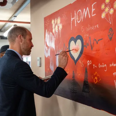 HRH Prince William contributes to the painted mural at the Centrepoint head office