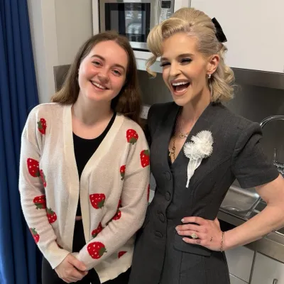 Kelly Osbourne and Ellie, a young person living at Reuben House, smile for the camera in her kitchen