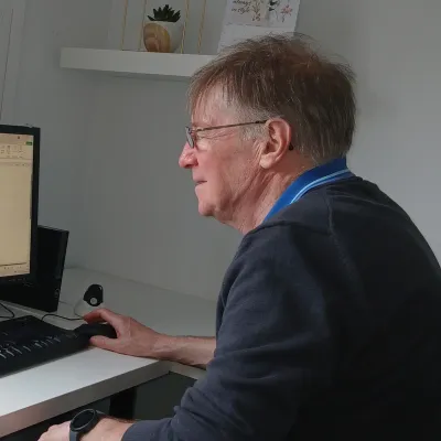 Profile of man sat at computer