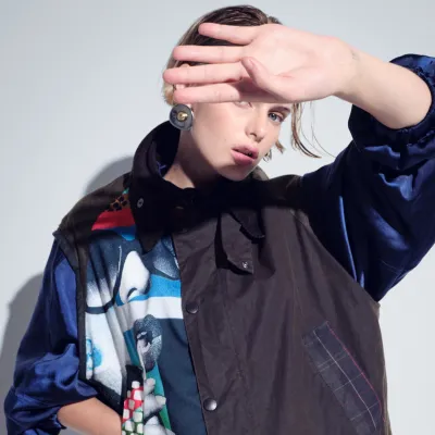 Model holding her hand up to the light wearing a gillet