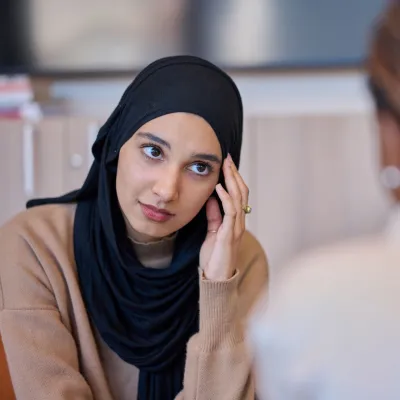 A nervous young woman speaks to a Centrepoint advisor for support